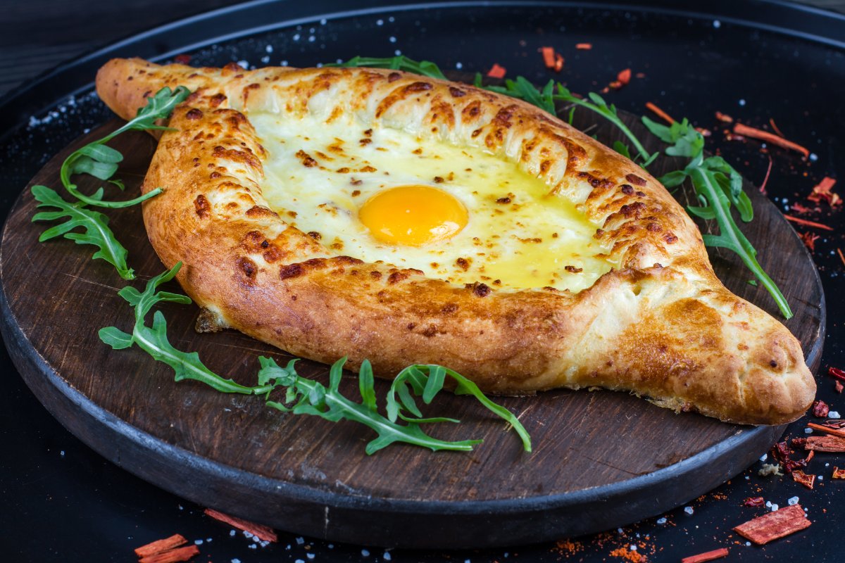 Adjaruli khachapuri with egg yolk and butter (illustration)